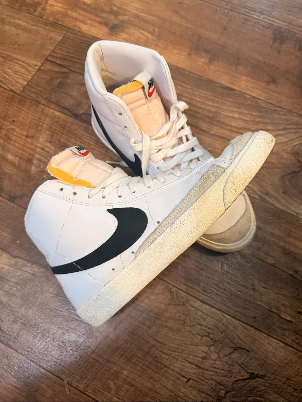 Nike White High-Top Sneakers with Black Swoosh and Yellow Tongue